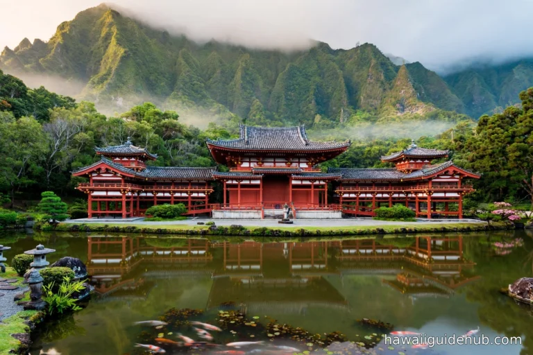 Byodo-In Temple with its red lacquered halls reflected in the koi pond, backed by the green Koolau mountains on Oahu Hawaii