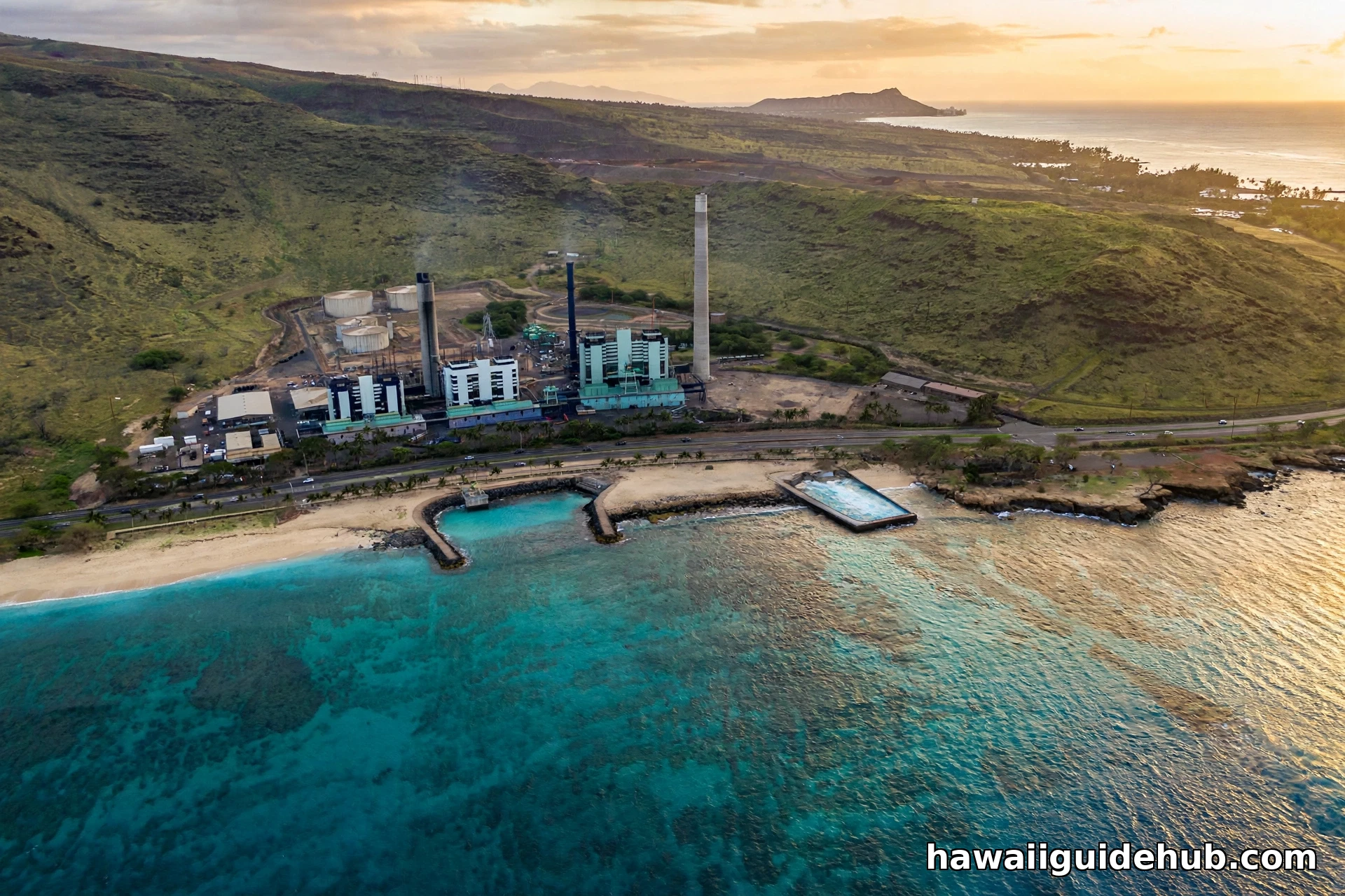 Aerial view of Electric Beach on Oahu at golden hour with the Kahe power plant across the highway