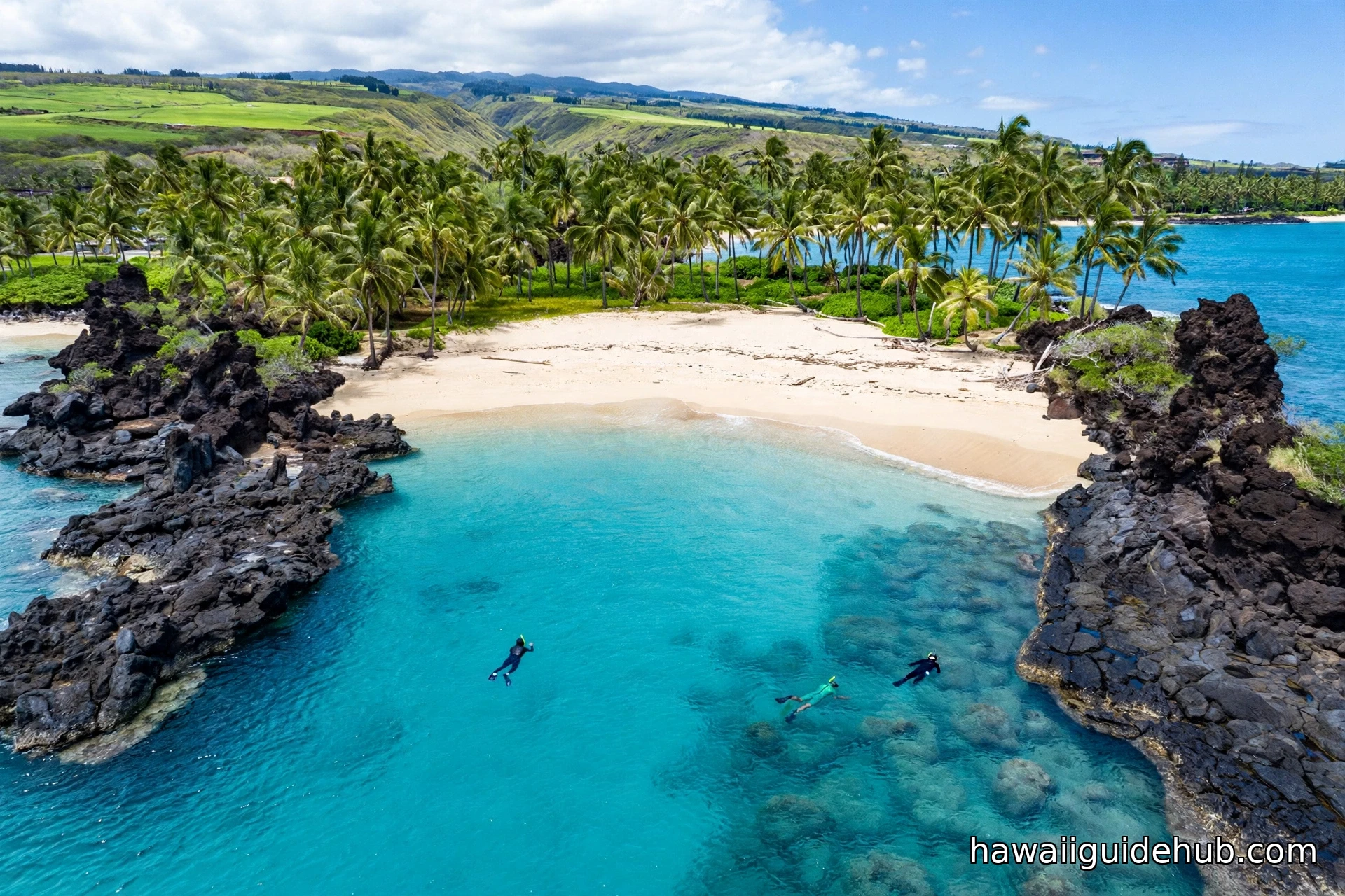 Aerial view of crescent-shaped Kapalua Bay on Maui with turquoise water, golden sand, palm trees, and black lava rock points framing the bay