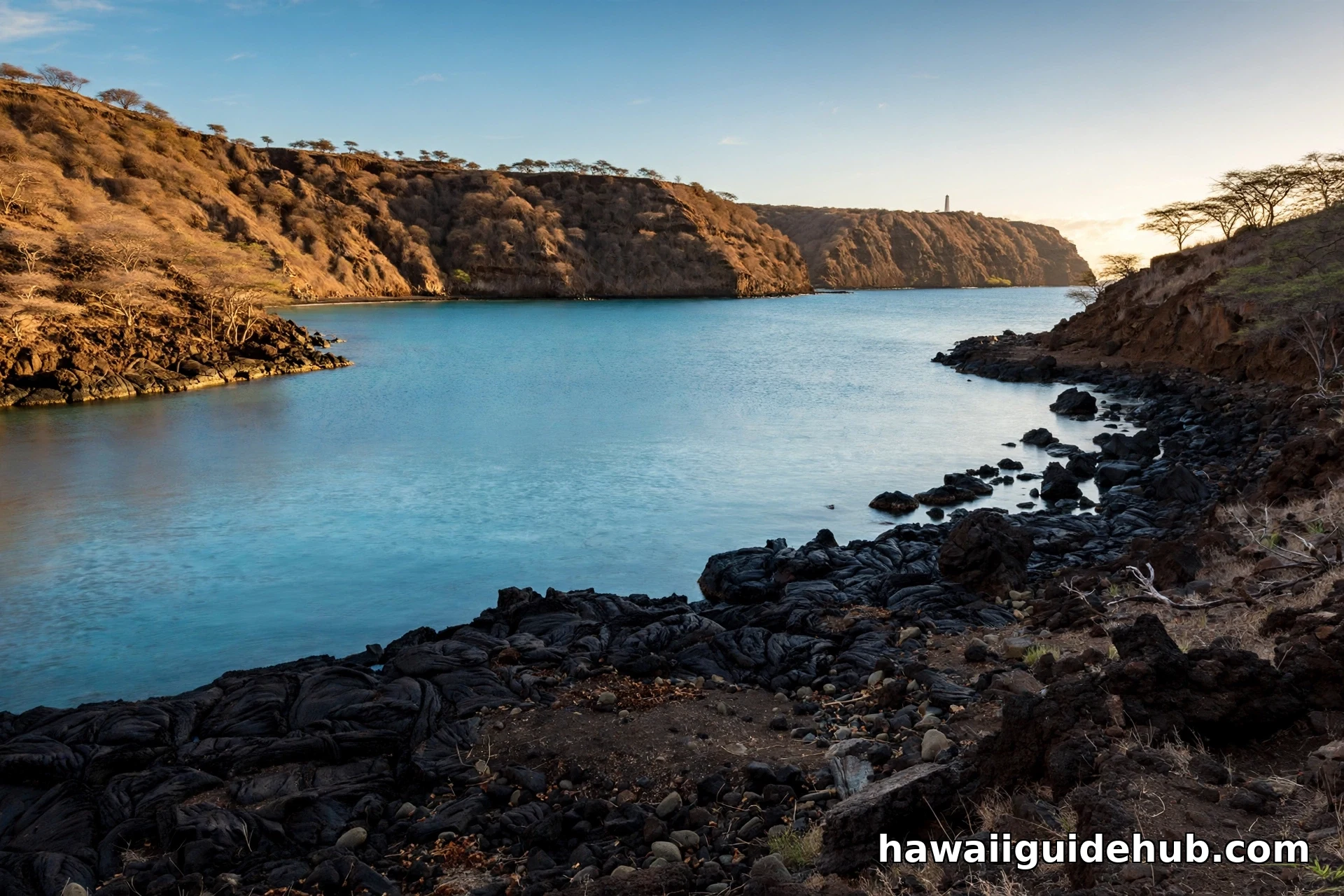 Black lava rock coastline with turquoise water and the view across Kealakekua Bay from Keʻei Beach