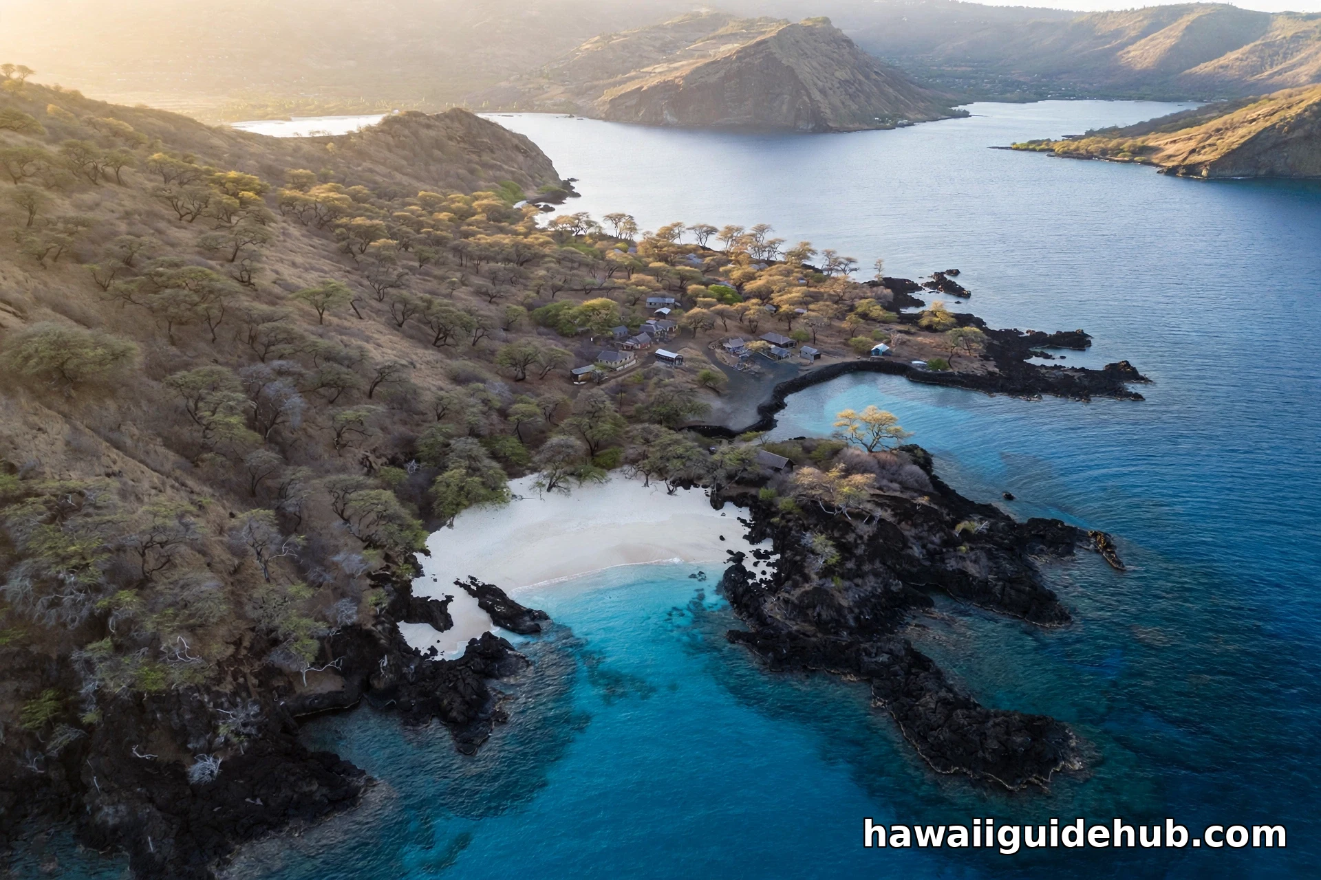 Aerial view of Ke'ei Beach, a white sand pocket framed by black lava rock on the Big Island Kona coast