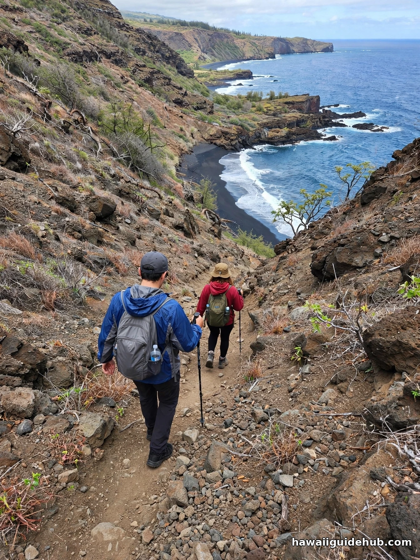 Hikers descending the steep trail to Kehena black sand beach, Big Island