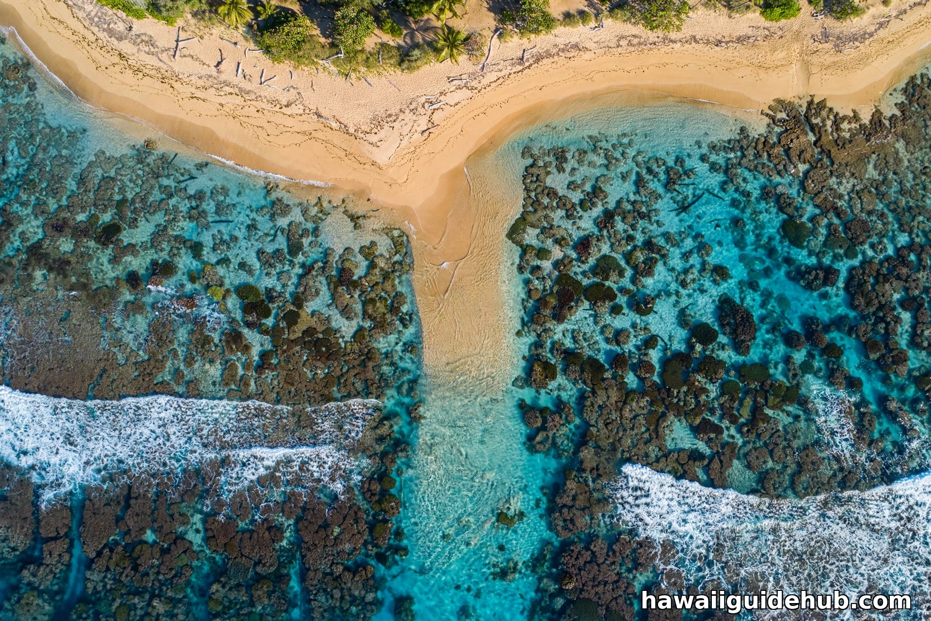 Aerial view of the fringing coral reef off Maluaka Beach with sandy entry channel visible through clear water