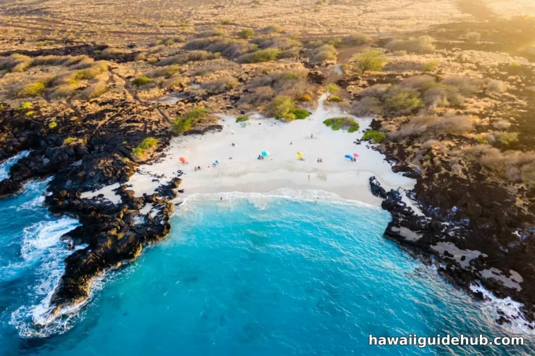 Aerial view of Maniniowali Beach (Kua Bay) on the Big Island of Hawaii, showing the white sand crescent between black lava rock and turquoise water