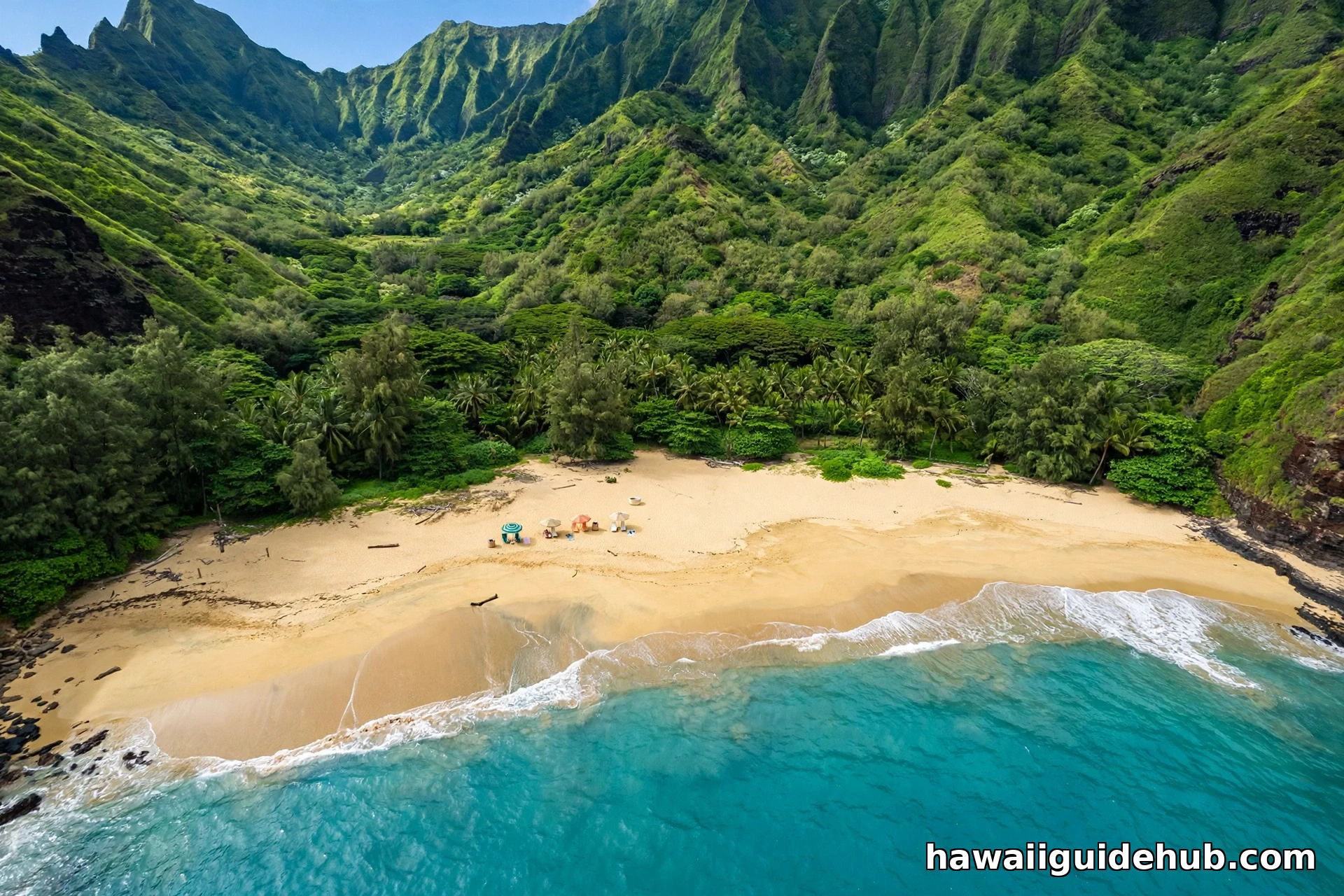Aerial view of a Kauai beach with turquoise water and green mountains