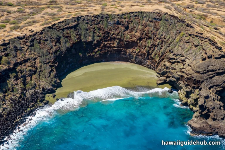 Aerial view of Papakolea Green Sand Beach on Hawaii Big Island, olive-green sand crescent inside the Puu Mahana volcanic crater with turquoise ocean