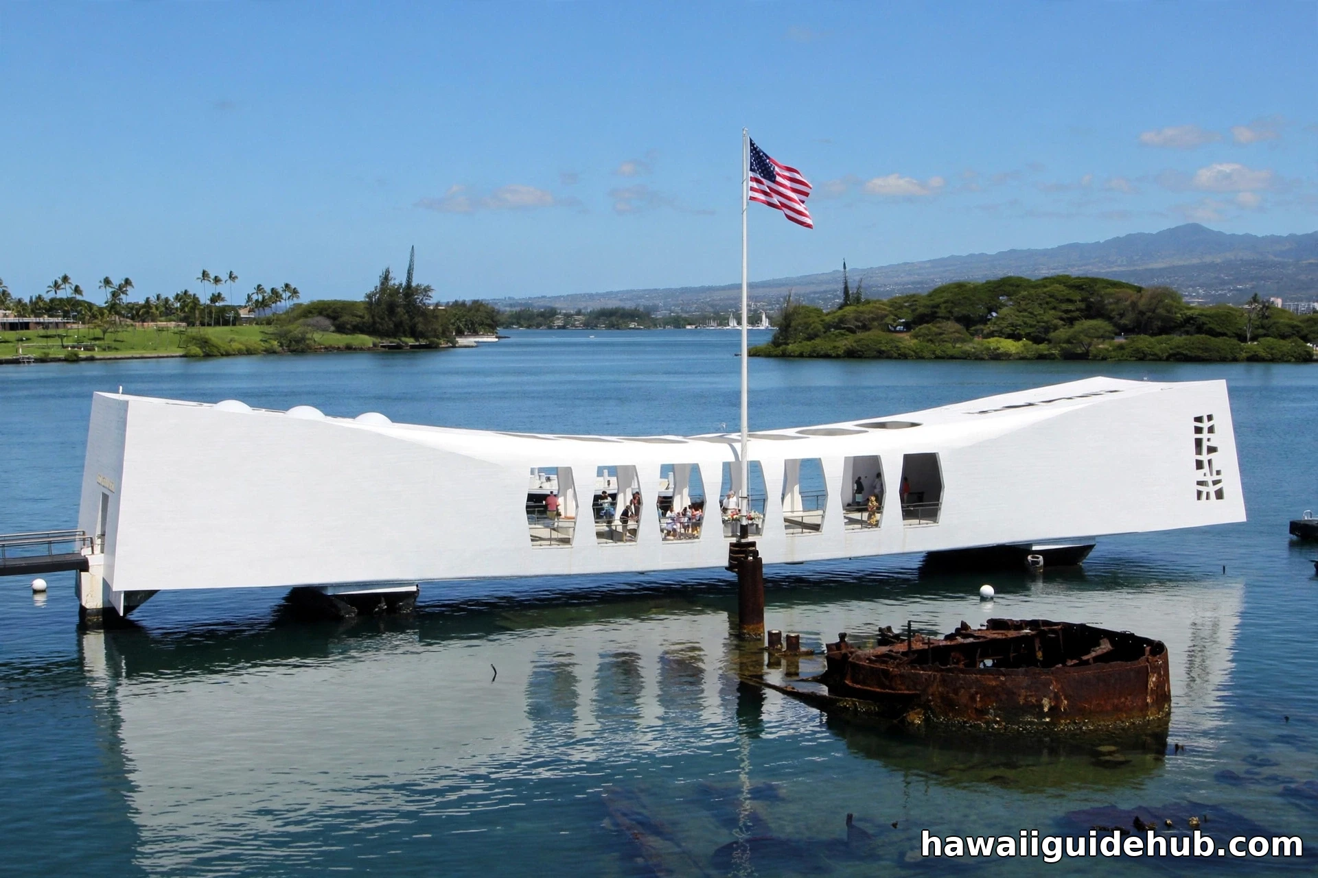 USS Arizona Memorial spanning the water at Pearl Harbor with American flag