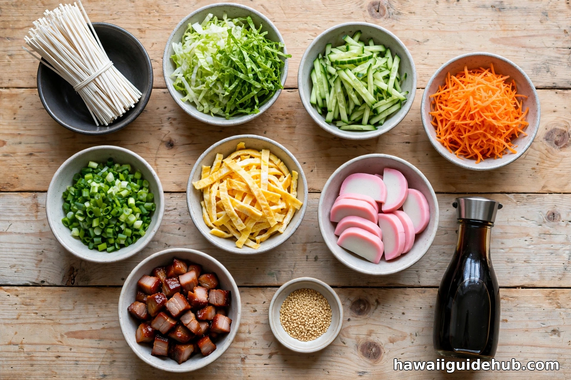 Small bowls of somen salad ingredients: dried somen, lettuce, cucumber, carrots, egg strips, kamaboko, char siu, sesame seeds, shoyu